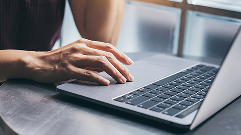 A close view of a person typing on a laptop