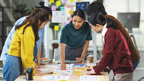 woman leading business creative team working together