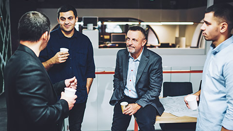 A group of colleagues talking about a presentation they just watched