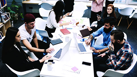 group team working on computer on table