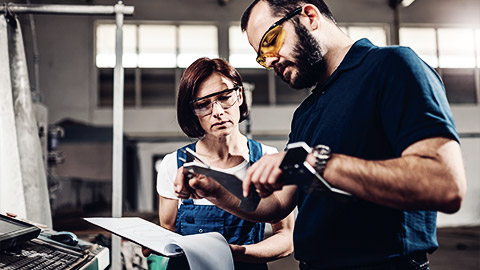 A person measuring parts from a cnc machine