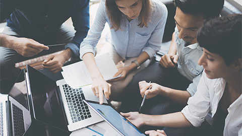 A group of colleagues reviewing documentation together