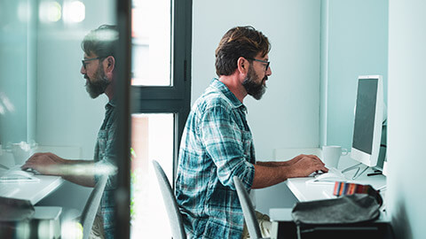 An accountant sitting at a desk working on spreadsheets