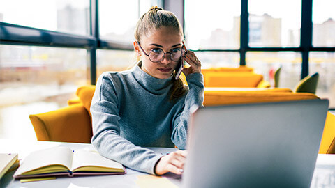 A finance team member on the phone with a creditor, validating their account details