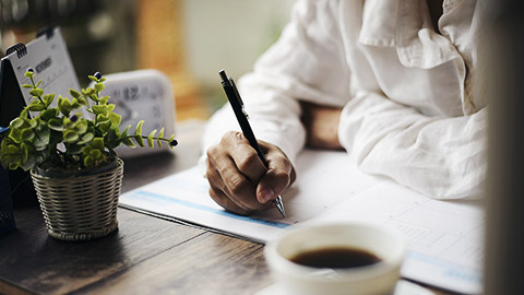 A person writing on a calendar