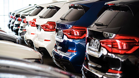 A close crop view of the rear of several vehicles