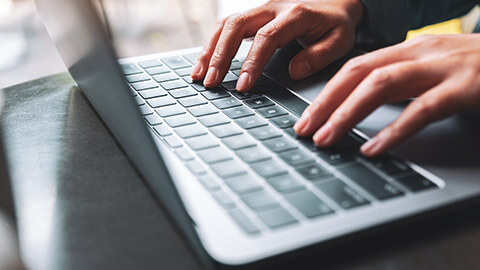 A close view of an accountant using a laptop