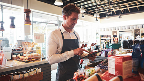 A business owner checning stock levels using a tablet device