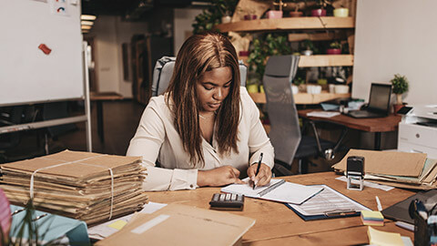 A small business owner doing paperwork in an office