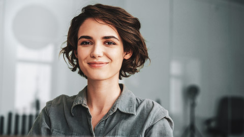 A smiling employee sitting in a modern office space