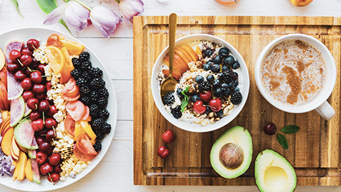 A top down view of a spread of healthy brekfast food on a table