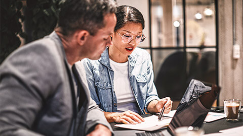 An Account Manager reviewing paperwork for discrepancies