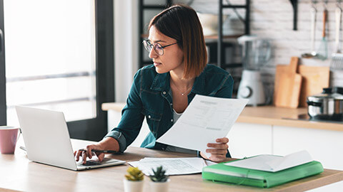 An accountant working on a laptop in a modern office space