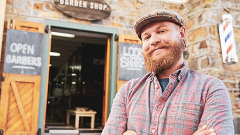 A small business owner smiling at the camera