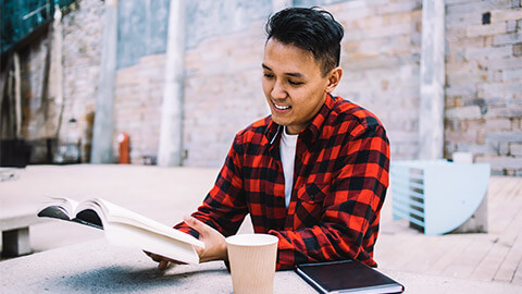 A person enjoying some time to themselves, absorbing a book that was recommended to them