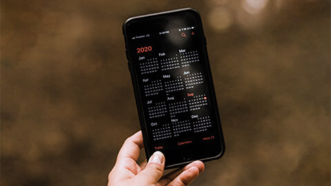 A person reviewing their schedule in their smart phone's calendar app