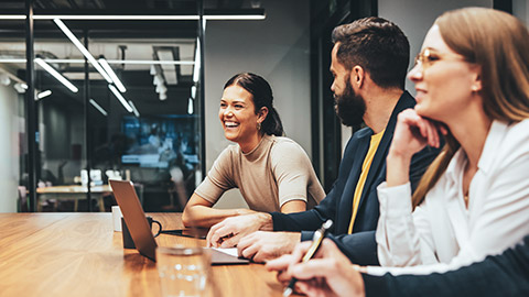 A group of engaged coworkers sitting in a modern office