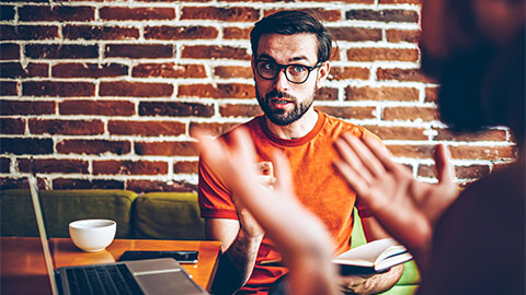 A team leader having a difficult conversation with one of their colleagues