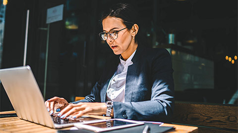 A manager seated in front of their laptop, working their way through their list of priorities for the day