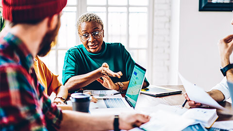 A project manager holding a meeting, delegating tasks to the wider team