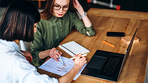 Two colleagues reviewing a project's estimated timeline