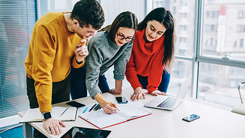 A small team taking notes during a casual meeting