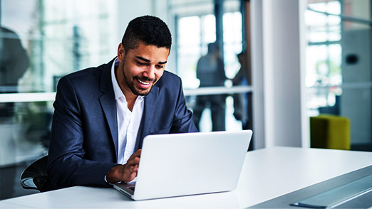 a young professional using a laptop for data visualization softwares