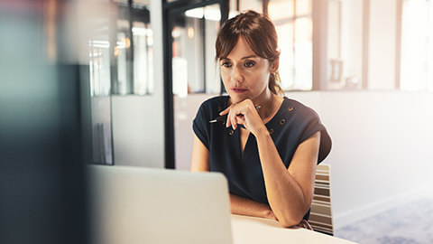 An analyst looking at data on a computer screen