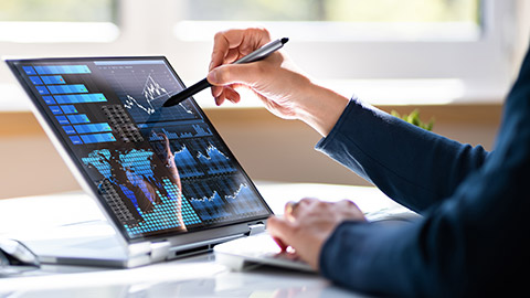 A close view of an analyst working with data on a tablet device