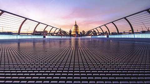 A low angle view of a footbridge leading to the US Capitol building in the distance