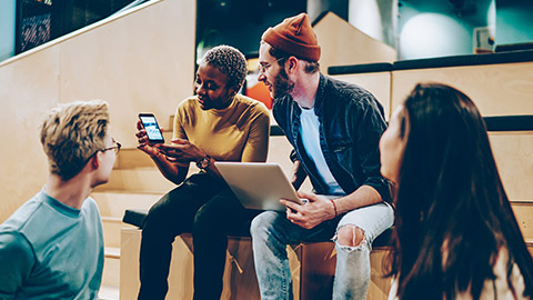 A group of designers testing usability on multiple devices