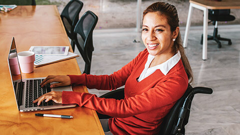 A learner with special learning needs at a desk with a laptop