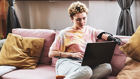 A person with a disability working on a laptop