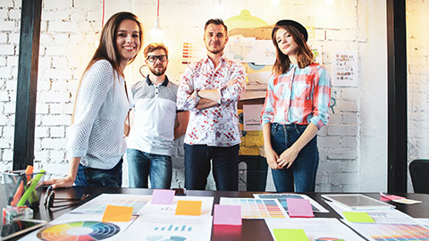 A group of designers looking toward the camera in a modern office