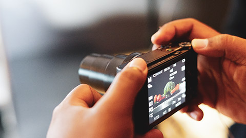 A person using a point and shoot camera