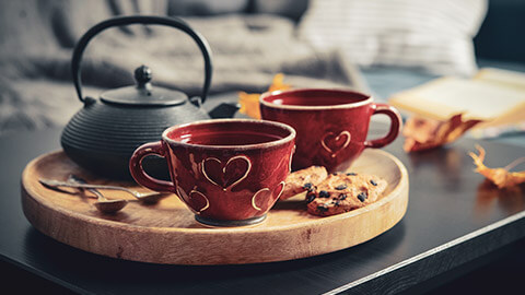 A close view of a tray of snacks and hot drinks on a table