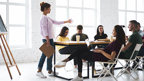 An instructor explaining concepts to a group of people