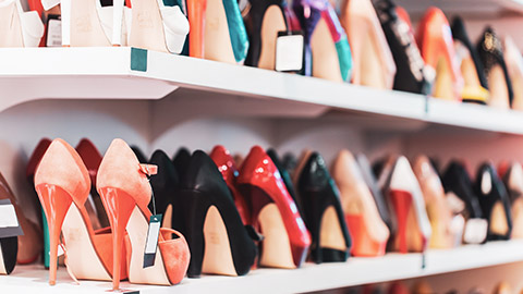 A close view of a shelf full of high heels in a shoe store