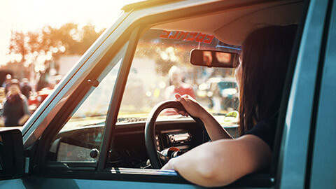 A young person cruising around in their newly purchased vehicle