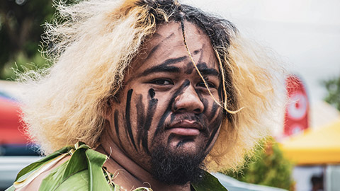 A pasifika man with tribal markings on his face