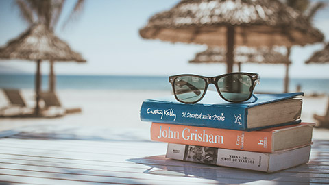 A marketing image for sunglasses in a holiday location