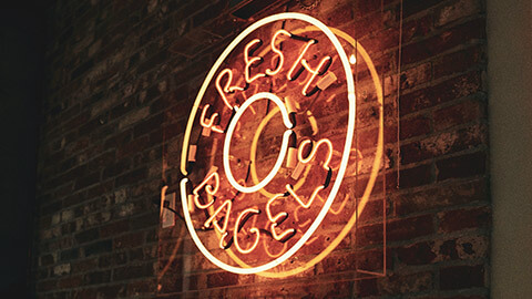 A close view of a sign advertising fresh bagels