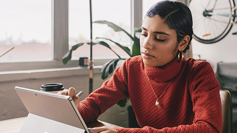 A young designer working on a tablet device