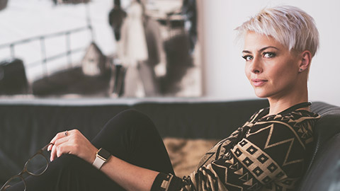 A female sitting on a couch is an example of a persona