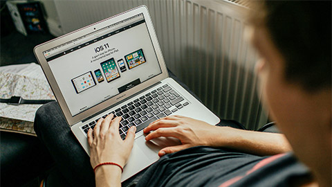 A user interacting with a website on their laptop