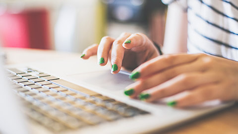 A close view of a person typing on a laptop