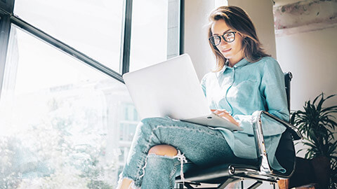 A designer working ona site on a laptop in a relaxed environment