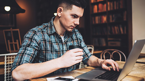 A designer working on migrating a CMS on his laptop