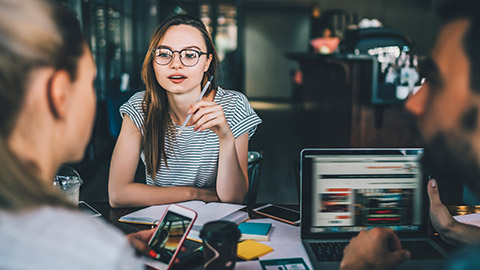 A designer talking to 2 clients about a project