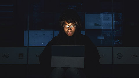 A designer testing a project on a tablet device in a dark room